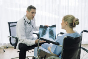 doctor showing patient xray of serious injury