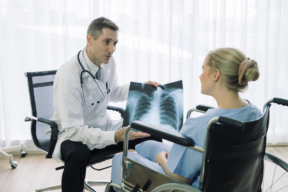 doctor showing patient xray of serious injury