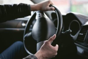 holding car steering wheel