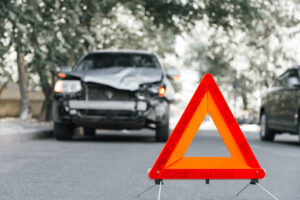 wrecked car sitting behind accident sign