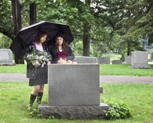 girls visiting grave