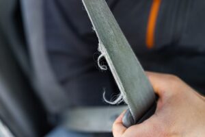 passenger holding onto seatbelt