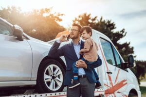 man holding his son after car accident