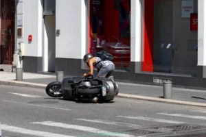 woman standing up next to motorcycle on the road