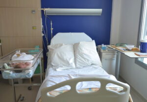 newborn in incubator inside a hospital room
