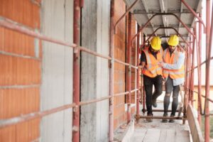 Construction worker helps injured coworker after accident