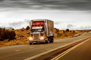 Red and Silver Truck on Asphalt Road