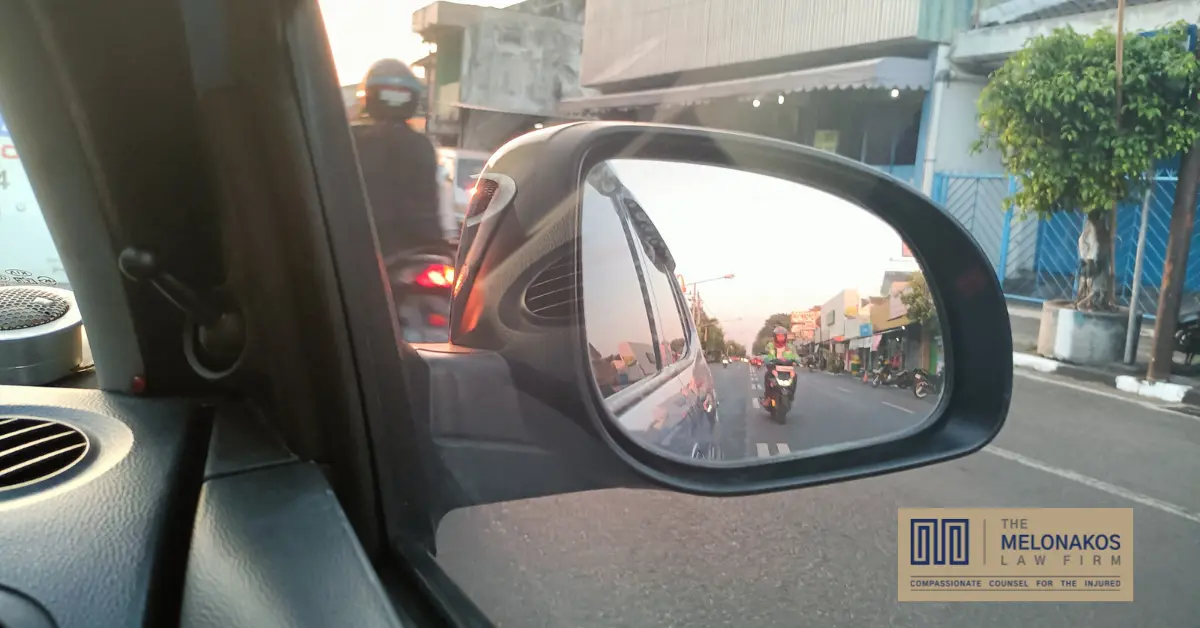 A motorcyclist riding in traffic on a South Carolina highway where drivers need to visually check before changing lanes