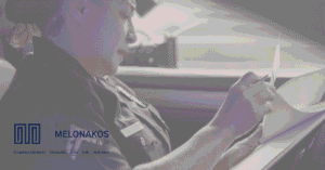 Police officer filling out a car accident report at a crash scene in Greenville